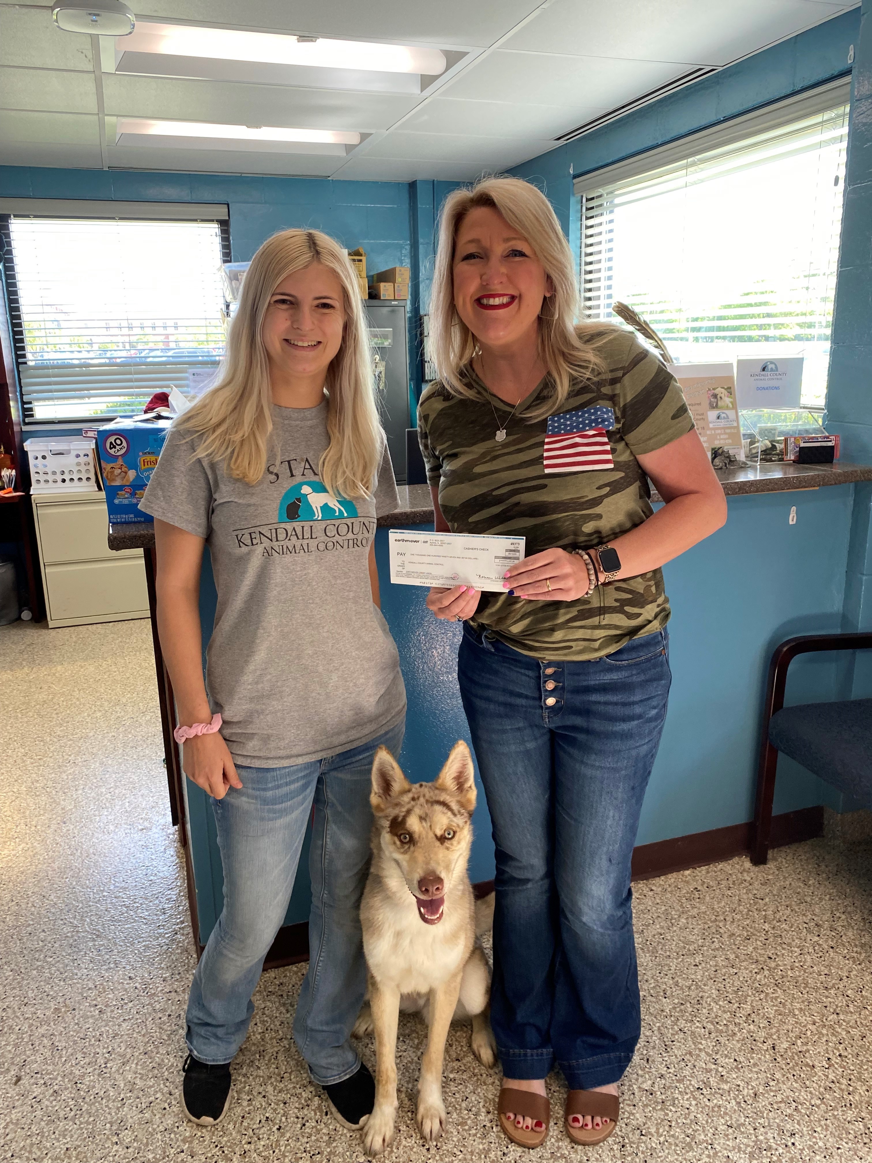 Two women with a check
