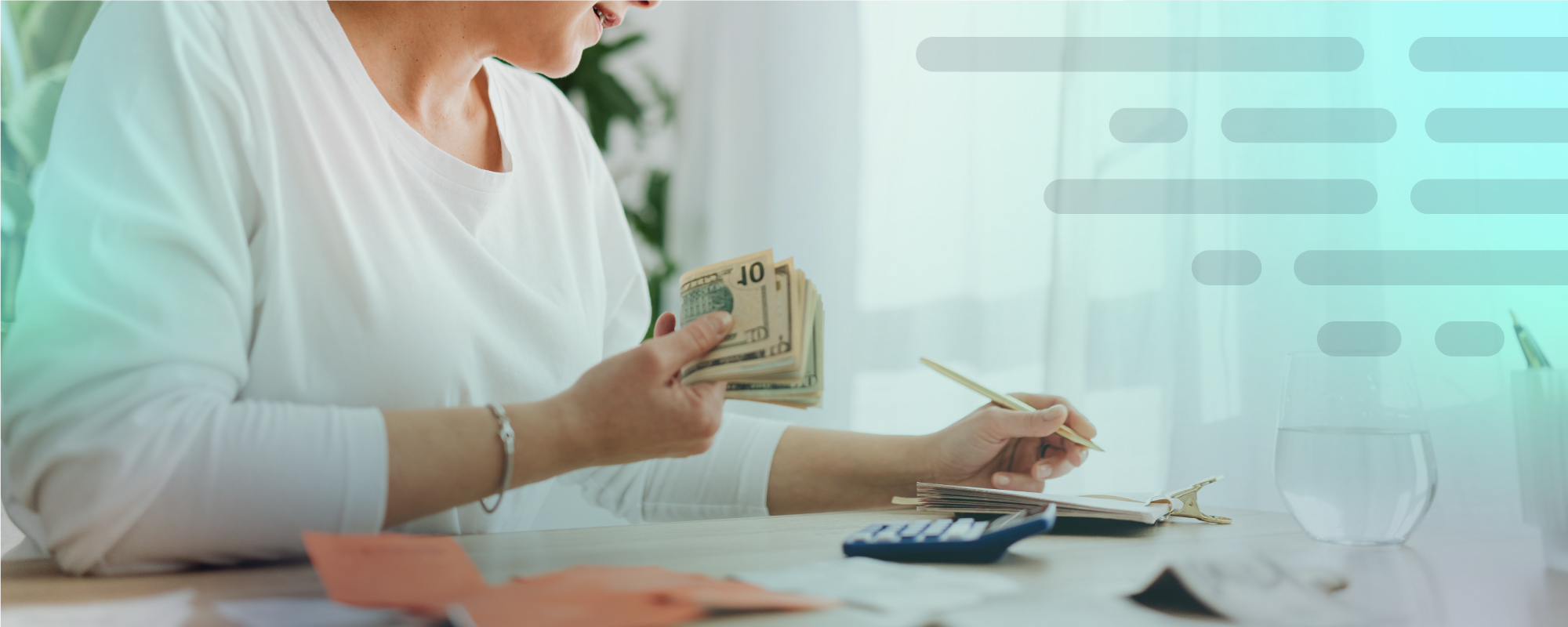 Woman at table with cash, calculator