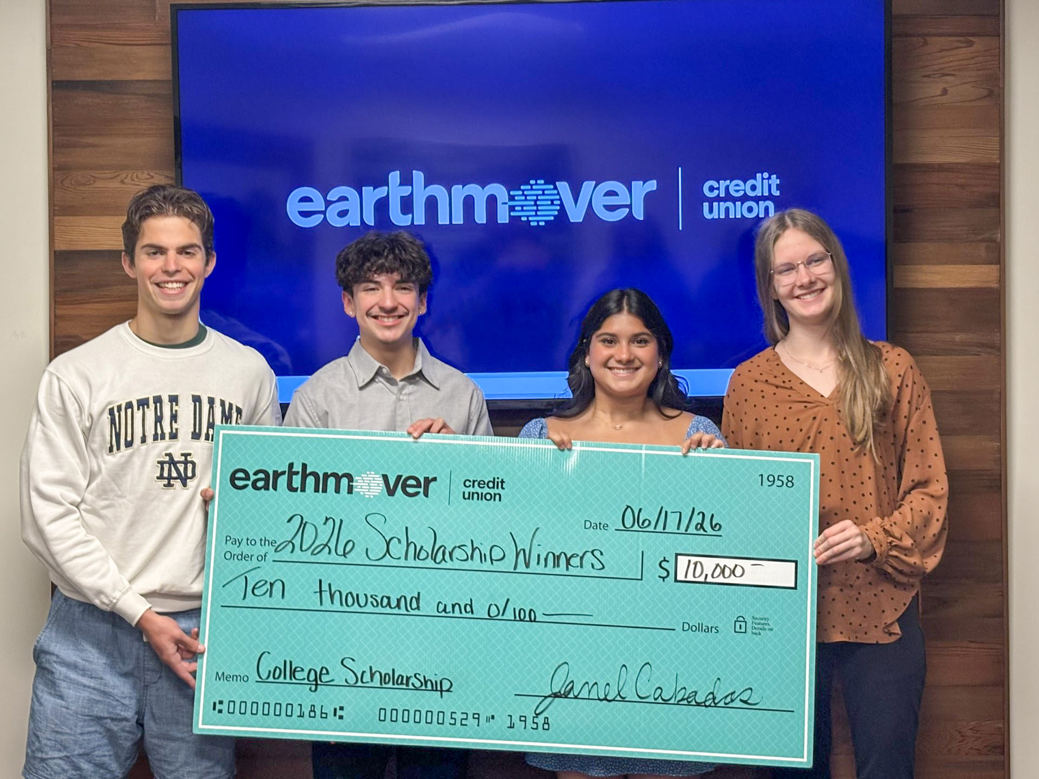Students posing with a giant check