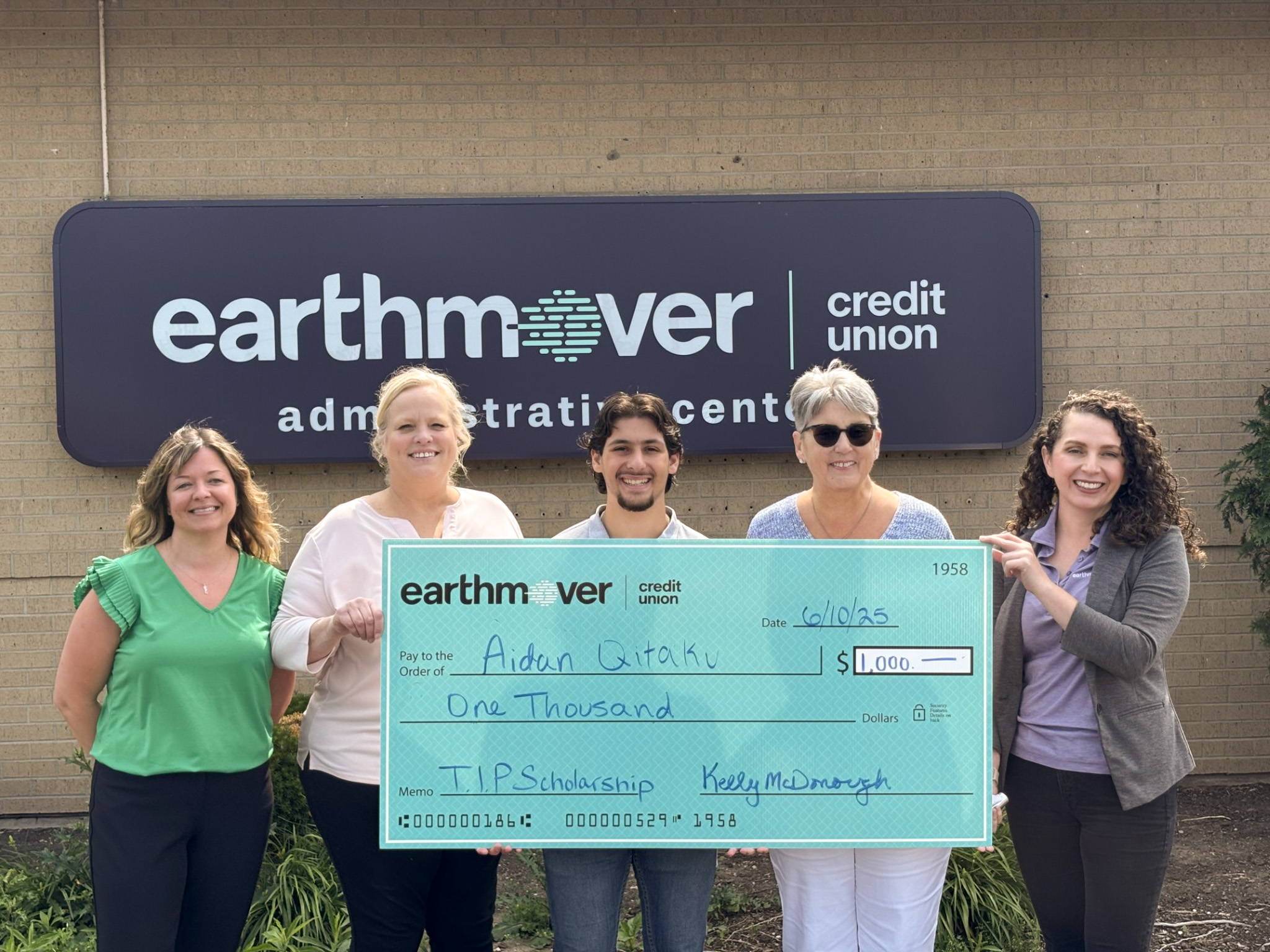 Group posing with giant check