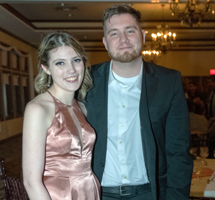 Woman in pink dress, man in suit