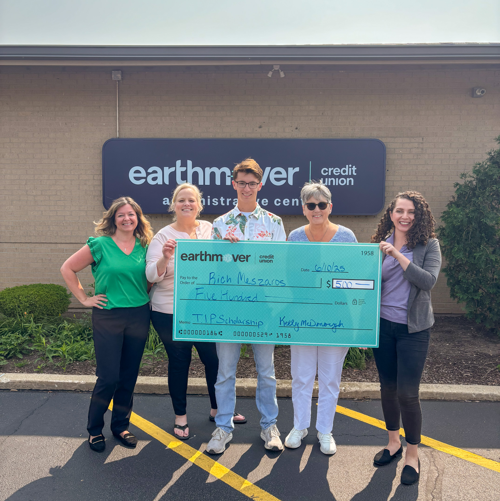 Group posing with giant check