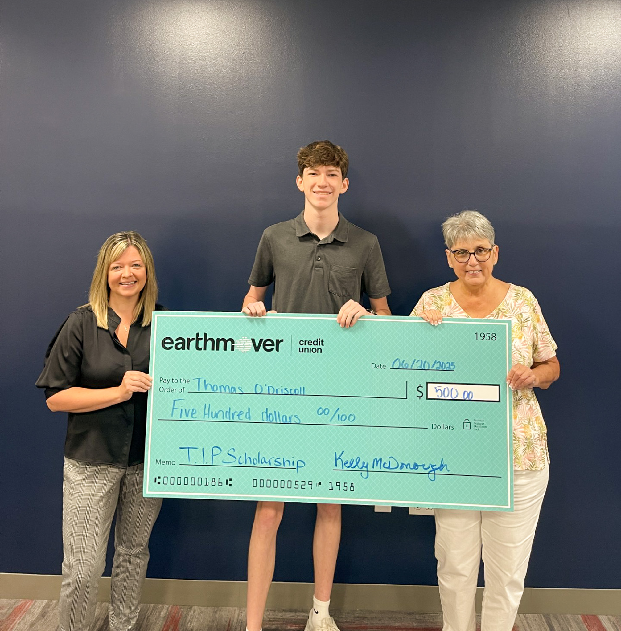 Group posing with giant check