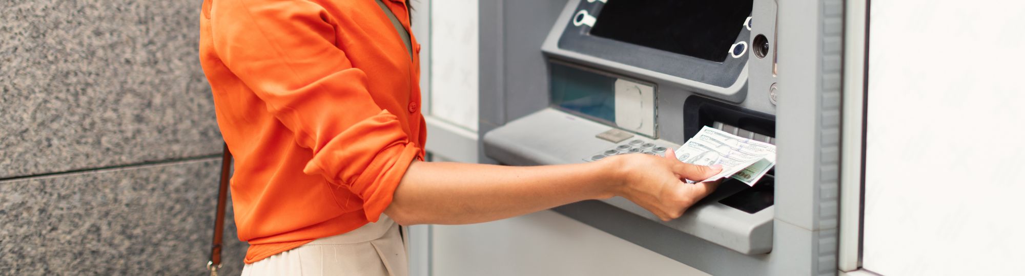 Woman using ATM